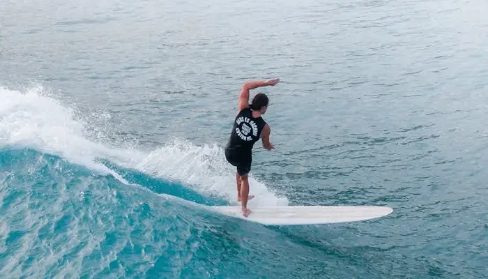 Man in Black Wetsuit Surfing on Blue Sea